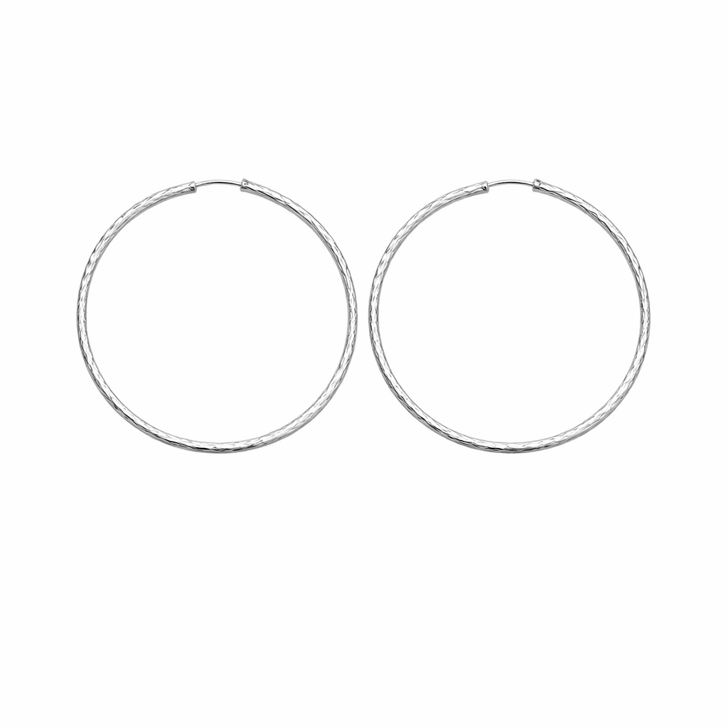 Pair of large silver hoop earrings on a white background