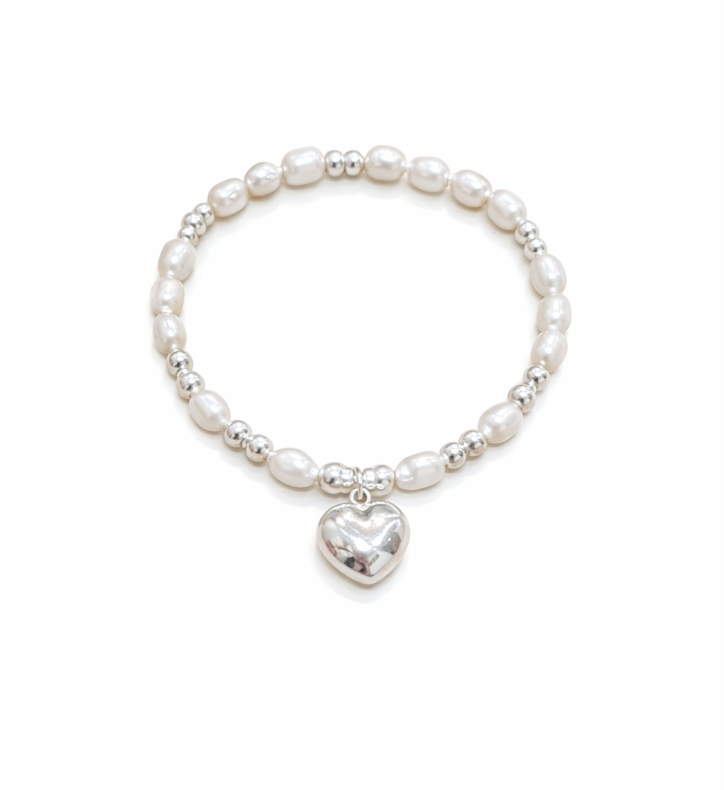 Pearl bracelet with a heart-shaped charm on a white background