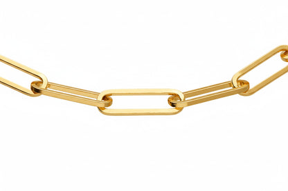 A close-up of a gold paperclip chain link necklace on a solid white background.