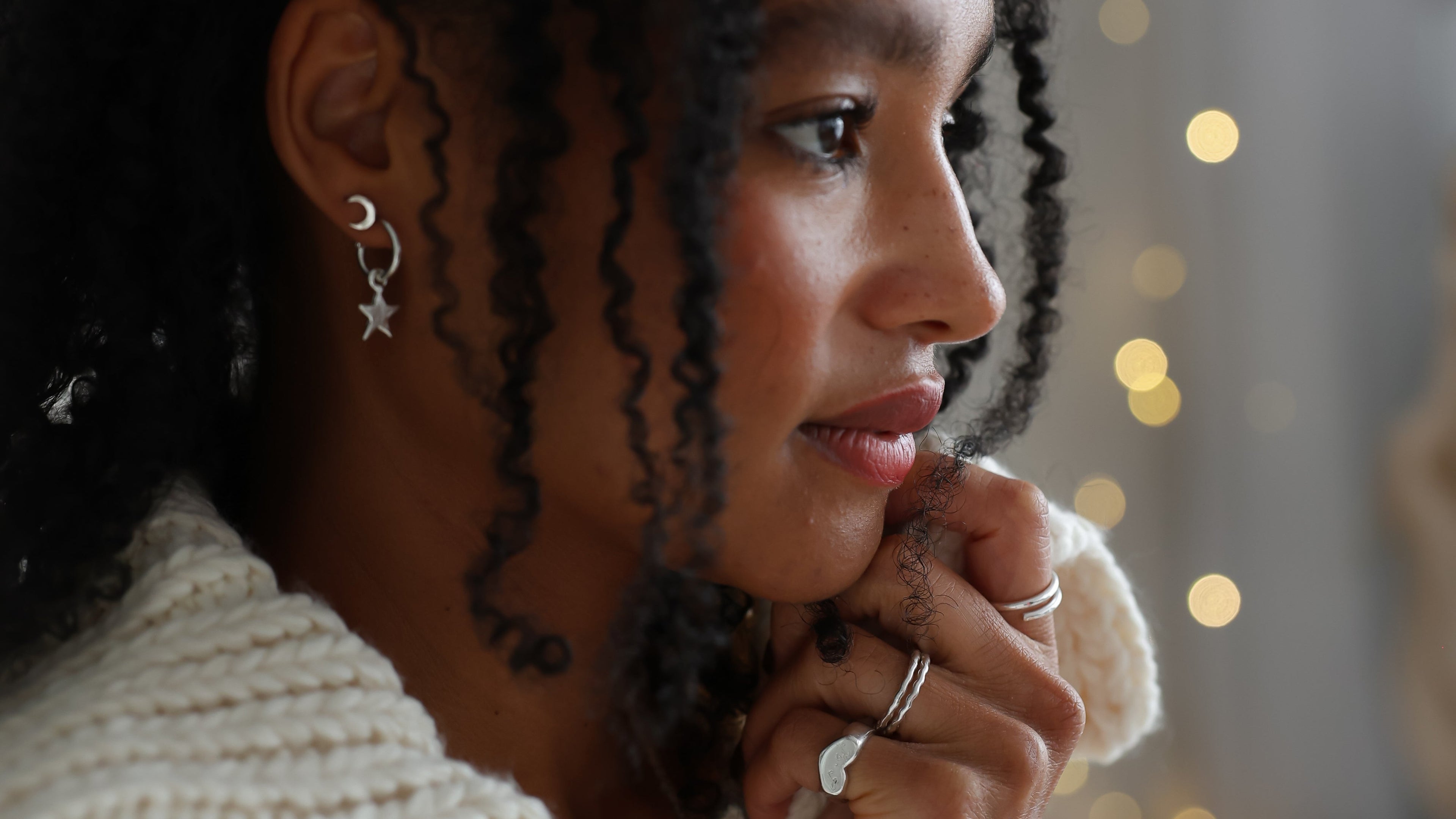 Woman with styled hair in a softly lit indoor setting