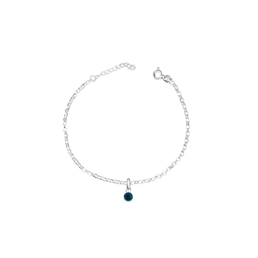 Silver bracelet with a green gemstone on a white background