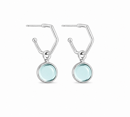 A pair of silverearrings with circular light blue aquamarine gemstones, shown on a plain white background.