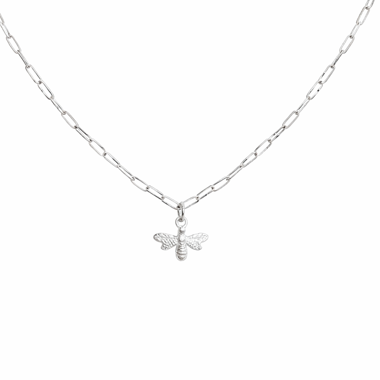 Silver bee necklace on a white chain against a white background