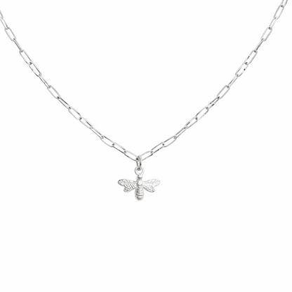 Silver bee necklace on a white chain against a white background