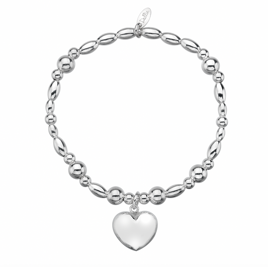 Puffed chunky heart charm on a beaded bracelet on a white background 
