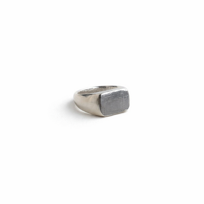 Silver signet ring on a white background