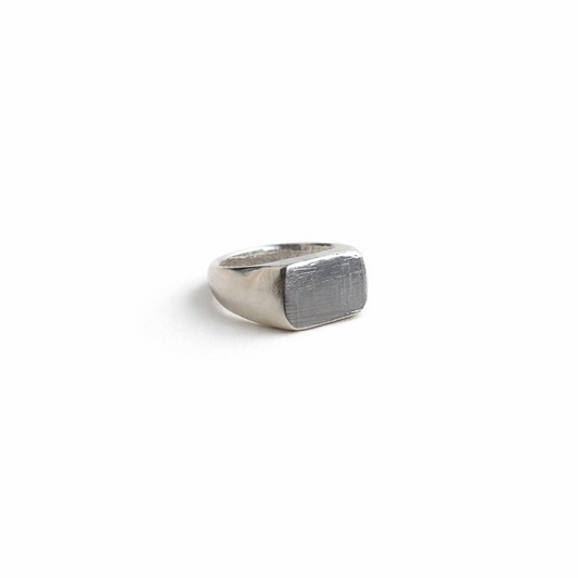 Silver signet ring on a white background