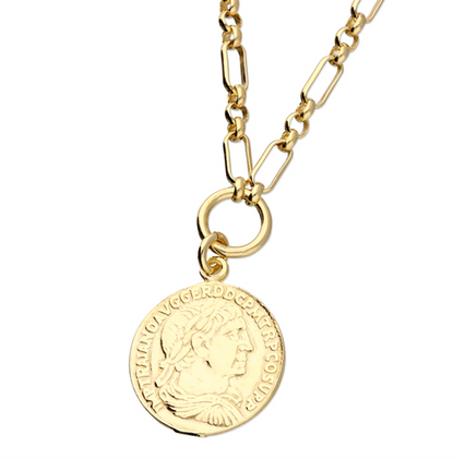 Gold necklace with a coin pendant on a white background