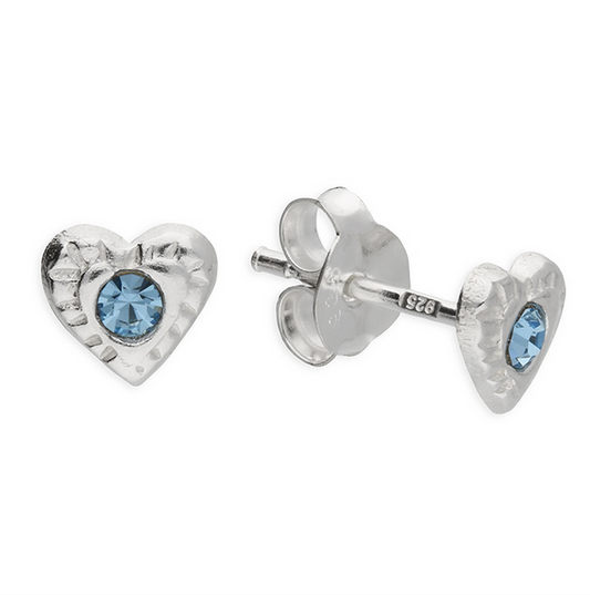 Heart-shaped silver earrings with blue gemstones on a white background