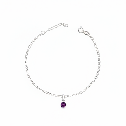 Silver bracelet with a purple gemstone on a white background