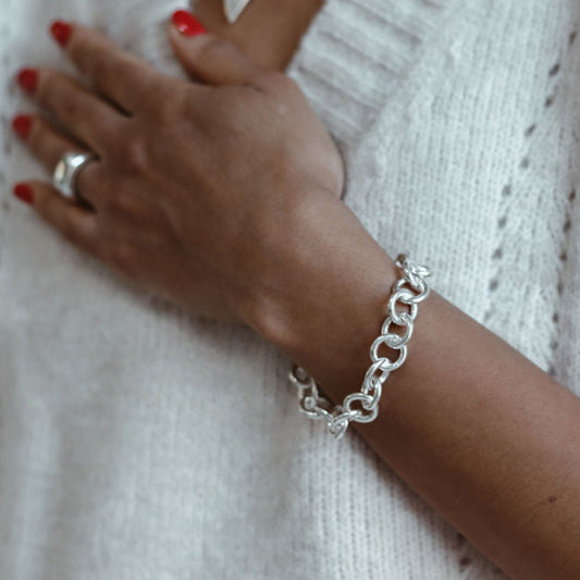 Chunky handmade sterling silver bracelet on Leanne 
