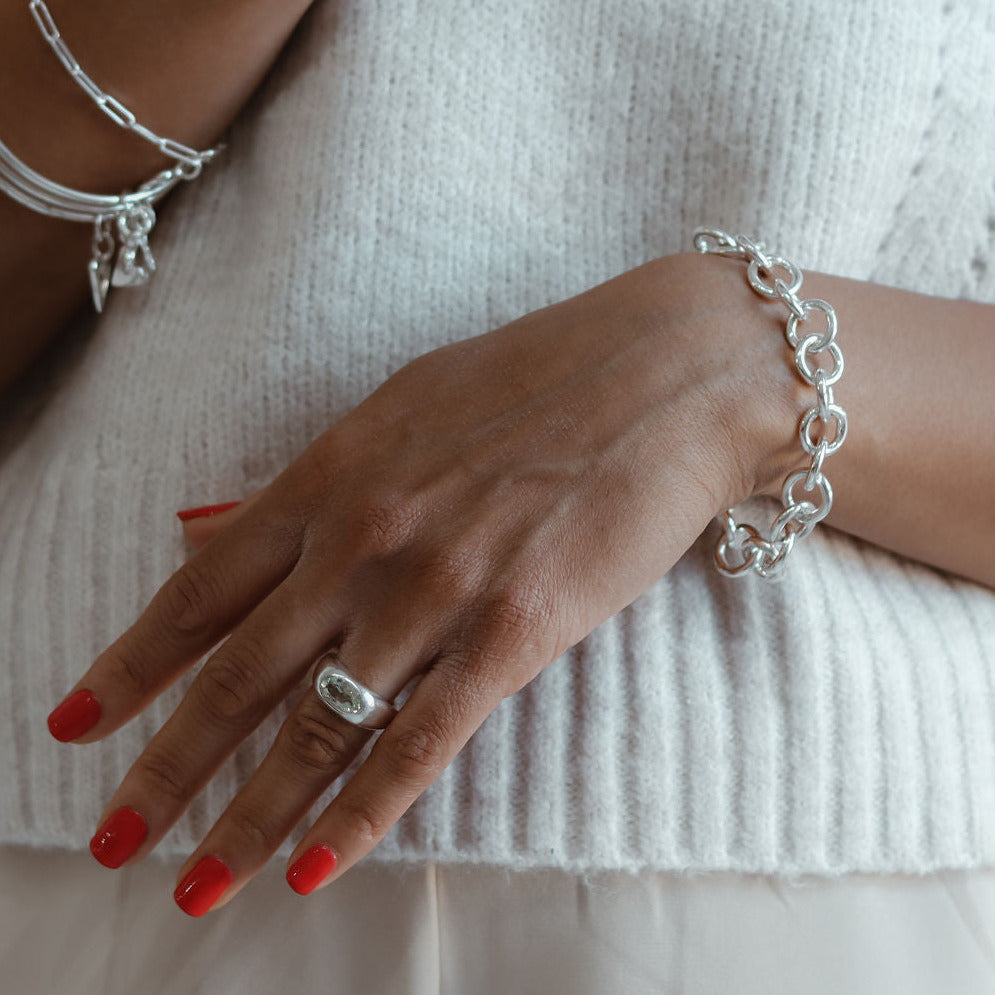 close up of a woman display a chunky silver bracelet 