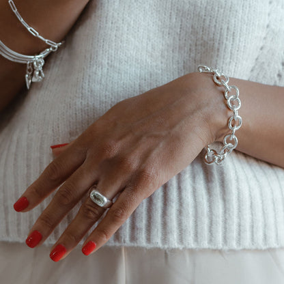 close up of a woman display a chunky silver bracelet 