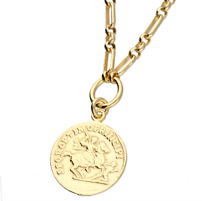 Gold necklace with a round pendant on a white background