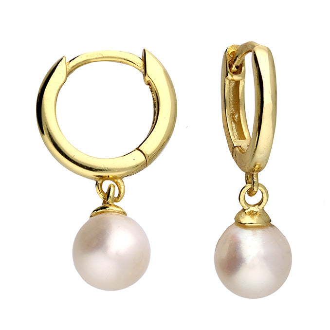 Gold hoop earrings with pearl drops on a white background