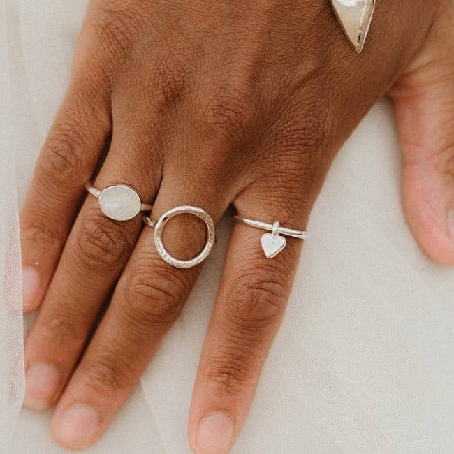 Silver Halo ring displayed with other handmade ring shown on Leanne 
