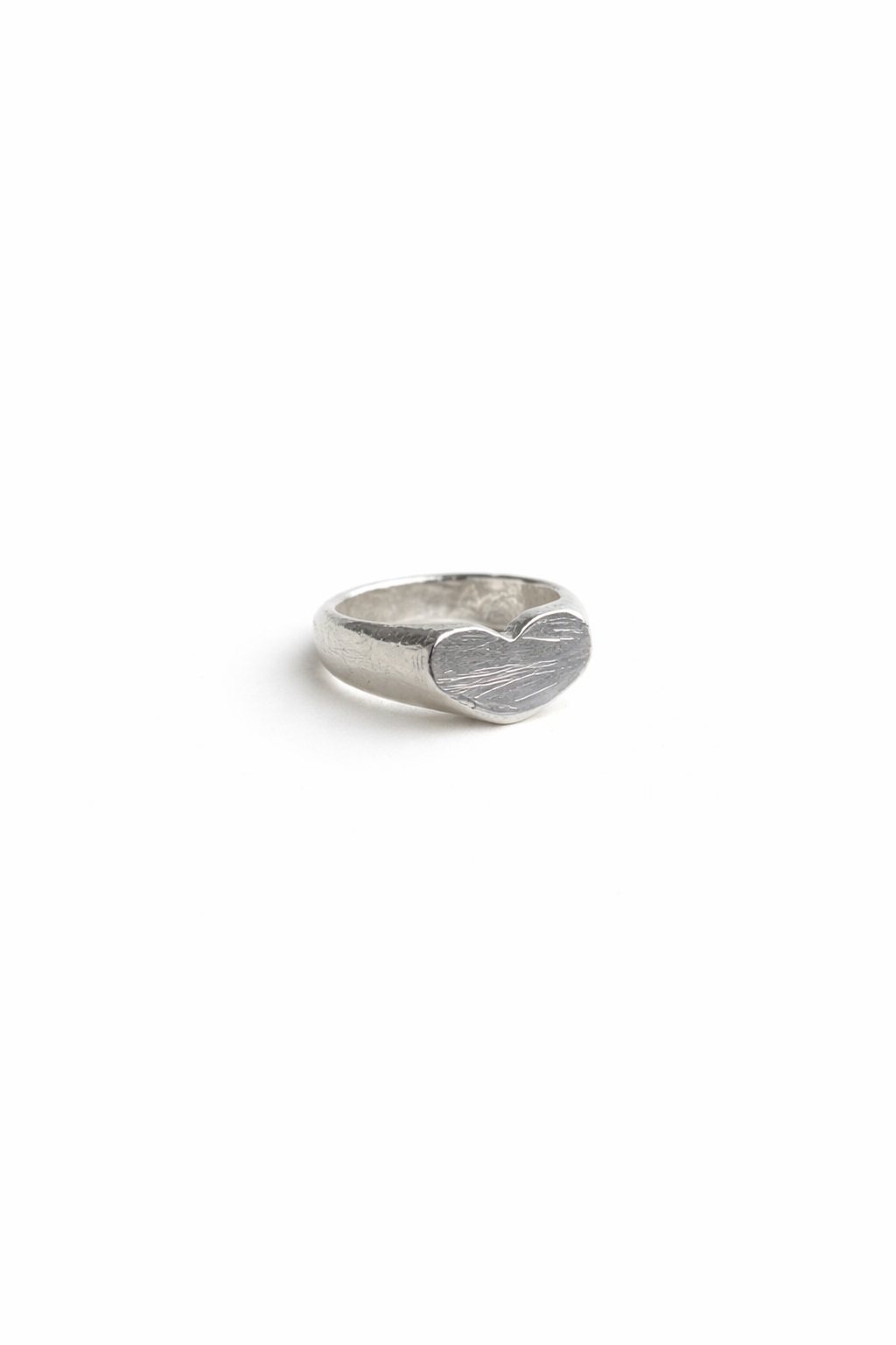 Silver heart-shaped ring on a white background