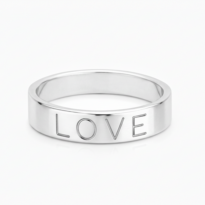 Silver ring with 'LOVE' engraving on a white background