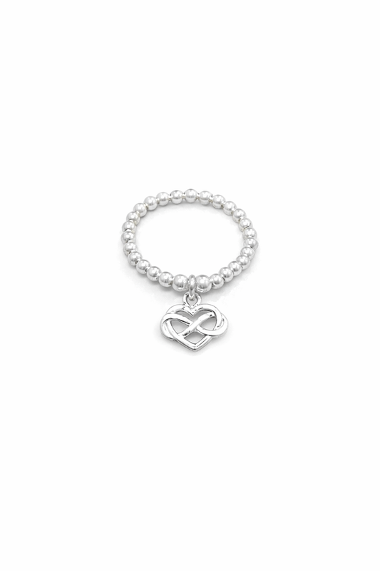 Silver beaded ring with a heart and infinity symbol charm on a white background