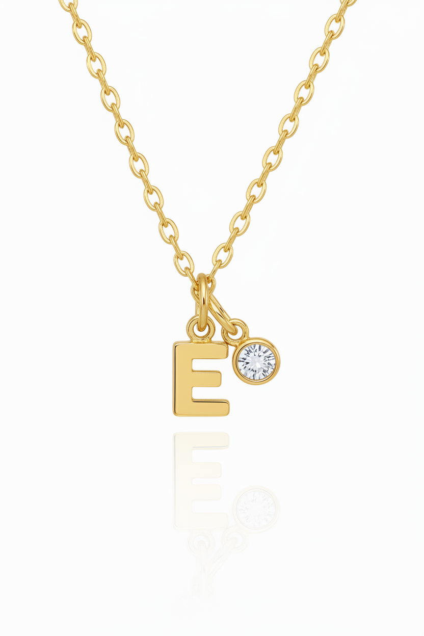Silver necklace with letter 'E' pendant on a white background with birthstone