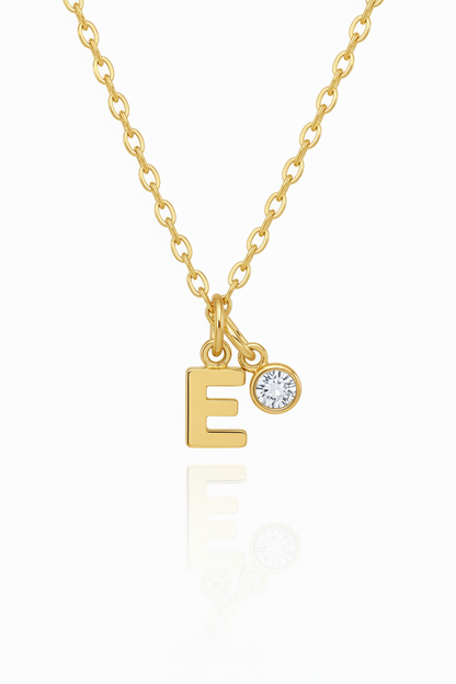 Silver necklace with letter 'E' pendant on a white background with birthstone