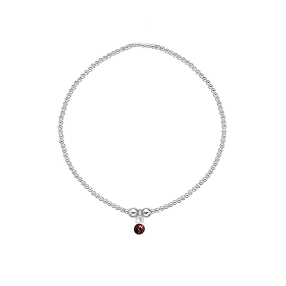 Silver beaded bracelet with a red crystal charm on a white background