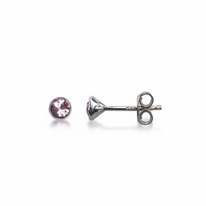 Pair of stud earrings with purple gemstones on a white background