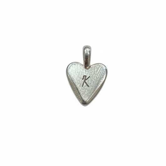 Silver heart-shaped pendant with a letter 'K' on a white background