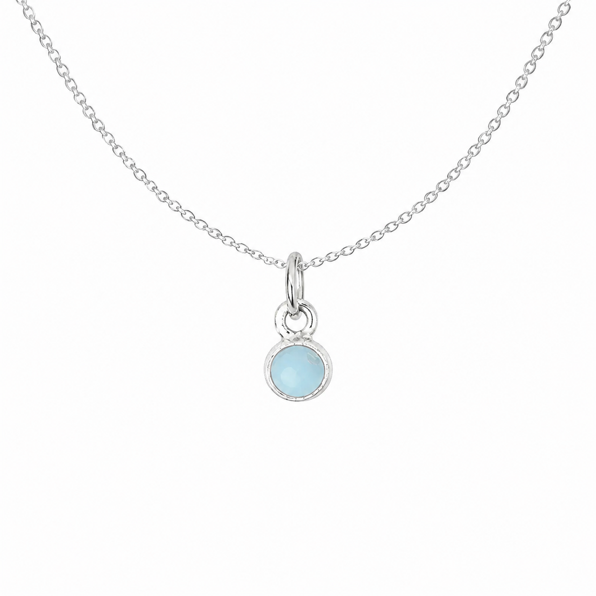 A delicate sterling silver chain necklace featuring a small round bezel-set light blue gemstone pendant, shown against a plain white background.