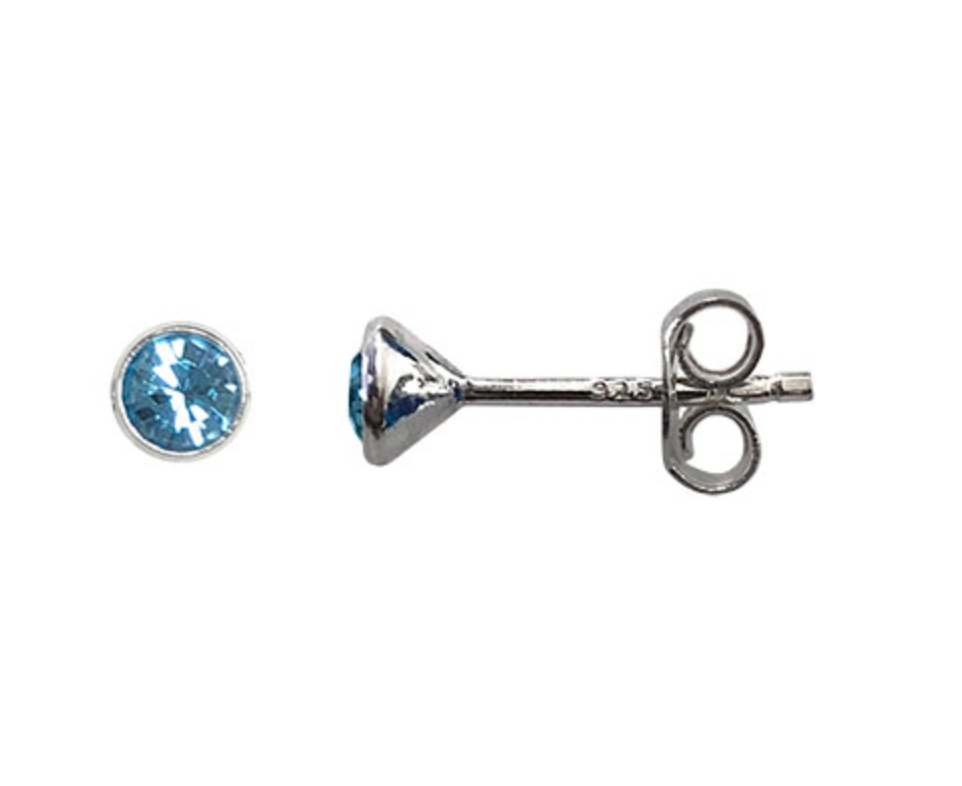 Silver earring with blue gemstone on a white background
