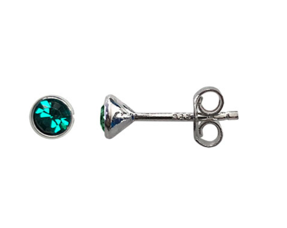 Silver earring with green gemstone on a white background