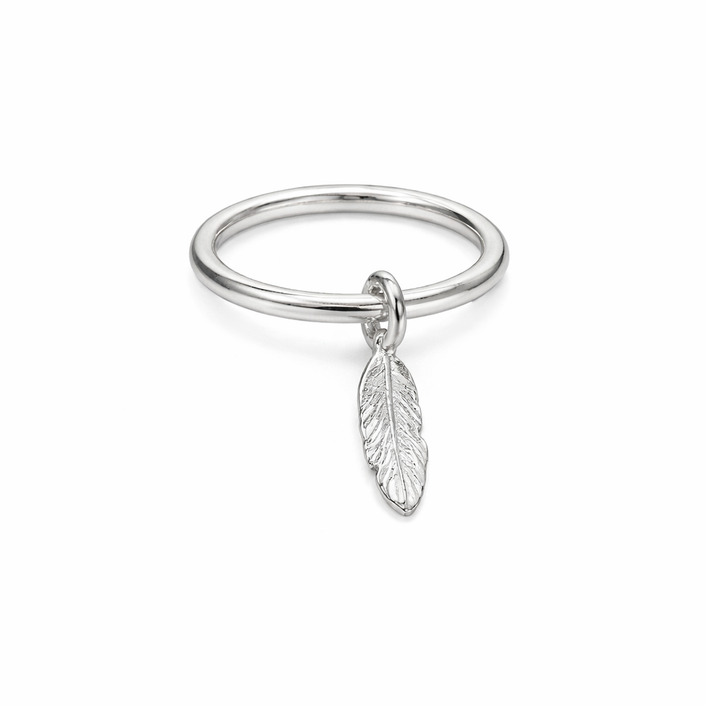 Silver ring with a feather charm on a white background