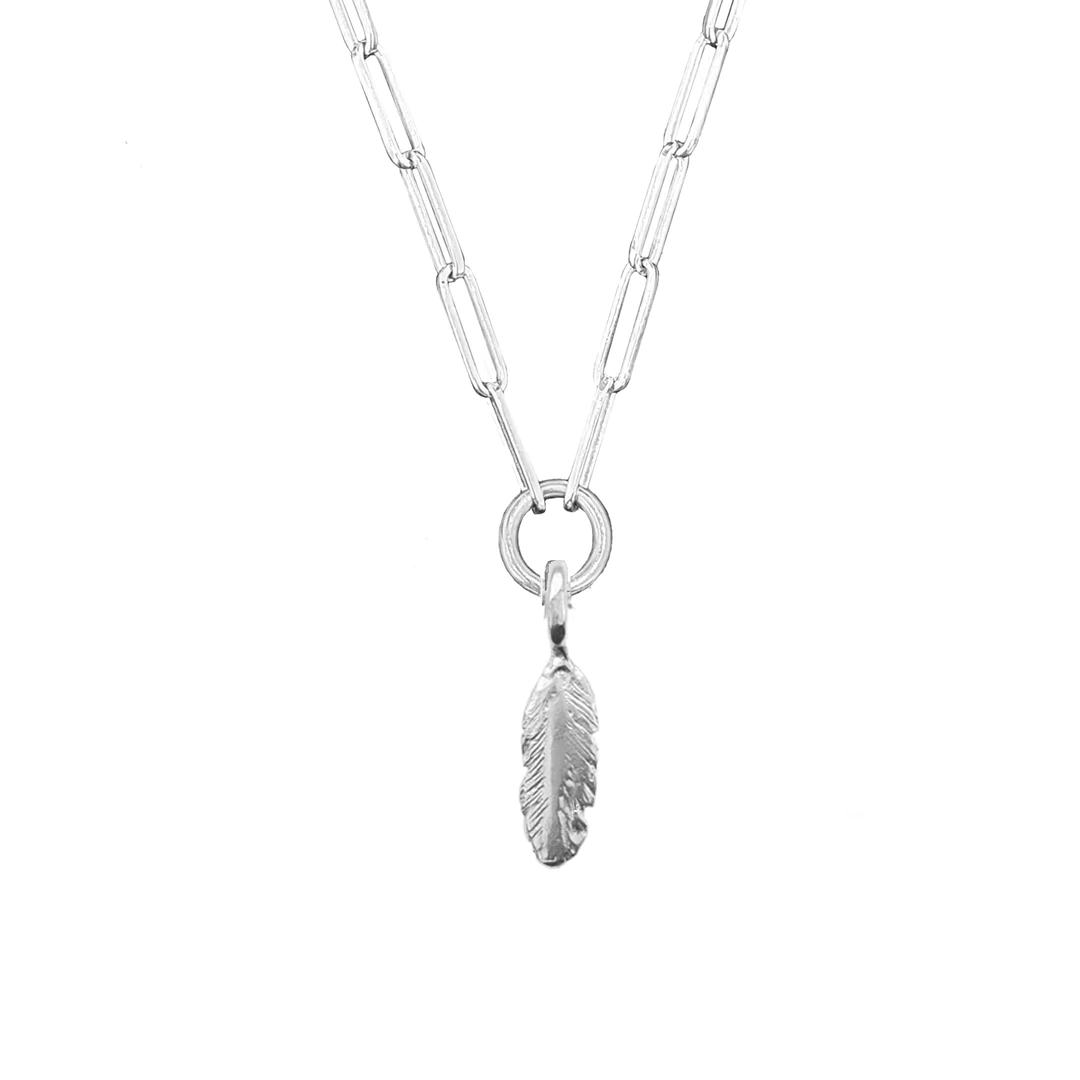 A sterling silver necklace with a trace chain link and a feather-shaped pendant.