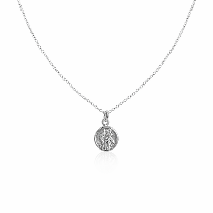 Silver necklace with a round st Christopher pendant on a white background