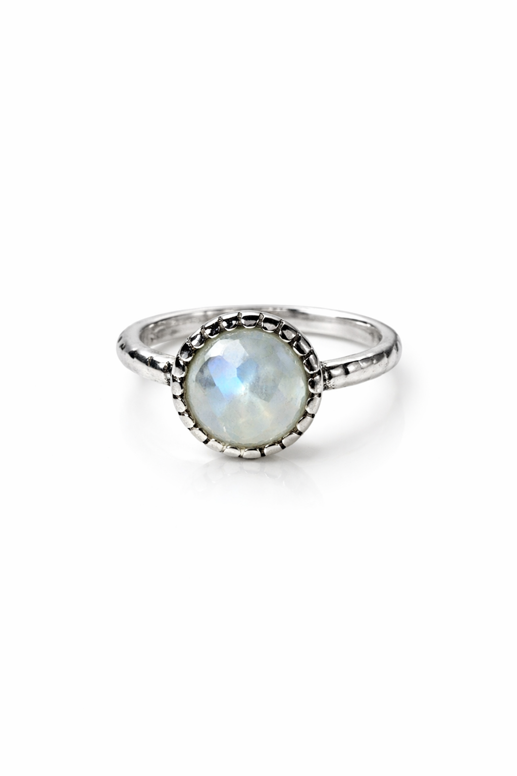 Silver ring with a round moonstone on a white background