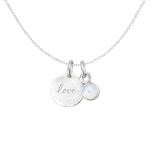 Necklace with 'love' pendant and moonstone on a white background