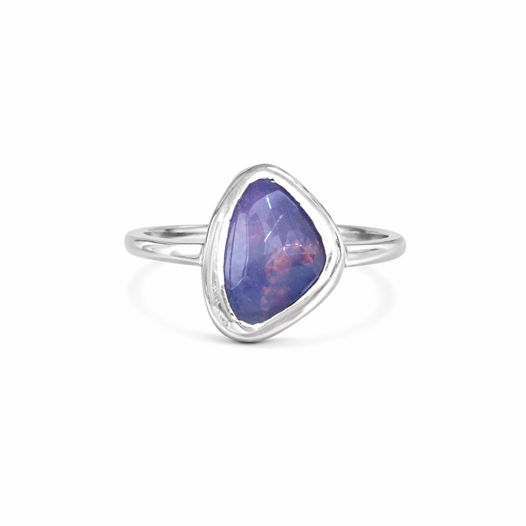 Silver ring with a austrialian opal stone on a white background
