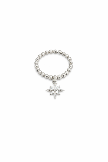 Silver beaded ring with a north shaped charm on a white background 