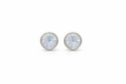 Pair of silver stud earrings with rainbow moonstone stones on a white background