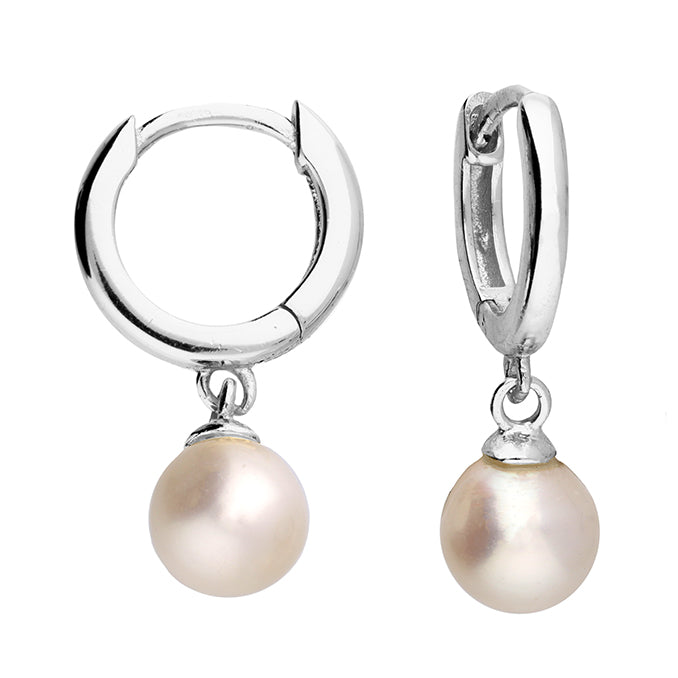 Silver hoop earrings with pearl drops on a white background