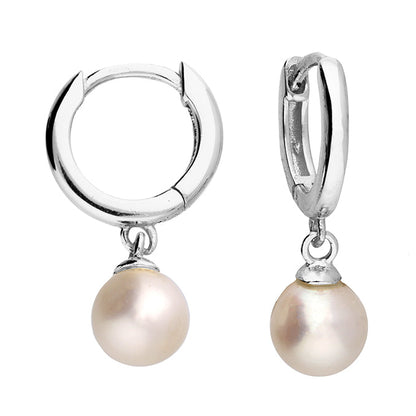 Silver hoop earrings with pearl drops on a white background