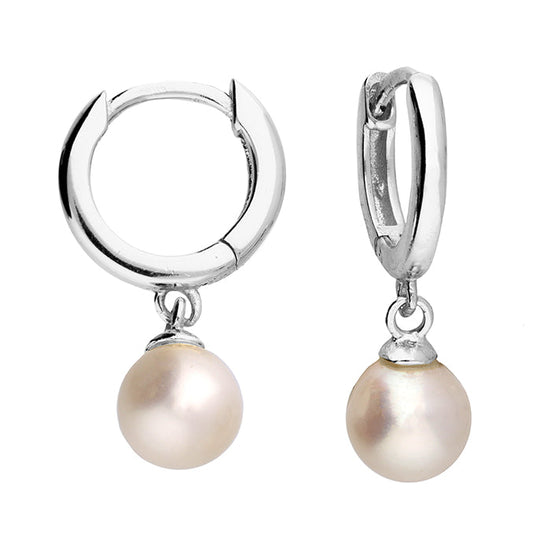Silver hoop earrings with pearl drops on a white background