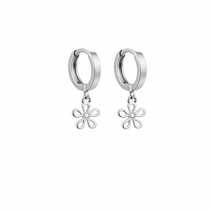 Silver hoop earrings with floral charms on a white background