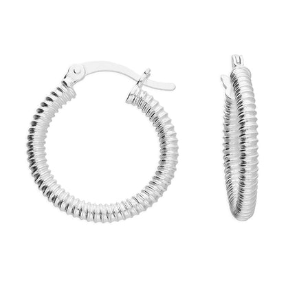 Silver ribbed hoop earrings on a white background