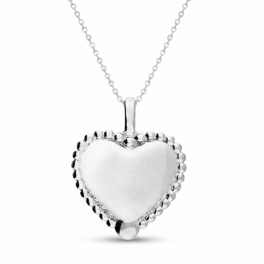 Silver heart-shaped pendant on a white background