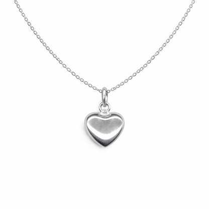 Silver heart-shaped pendant on a chain against a white background