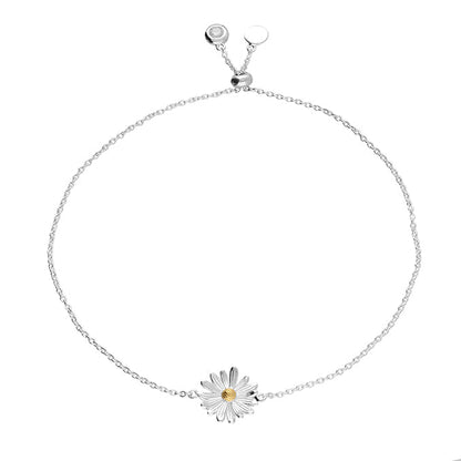 Silver bracelet with a daisy charm on a white background