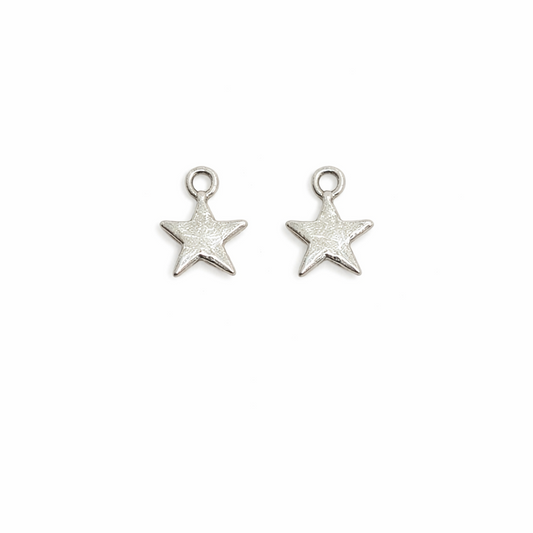 Two silver star-shaped charms on a white background