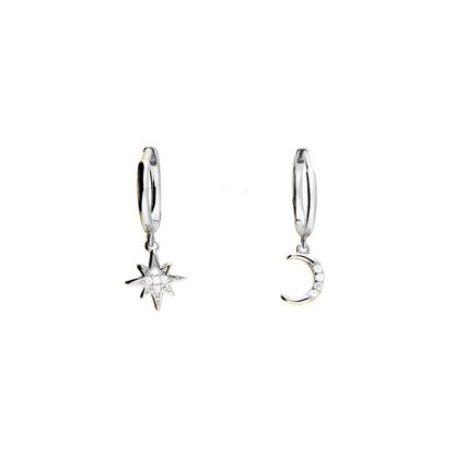 Pair of silver hoop earrings with star and moon charms on a white background