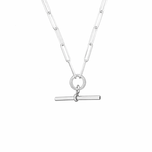 Silver necklace with a t bar pendant on a white background